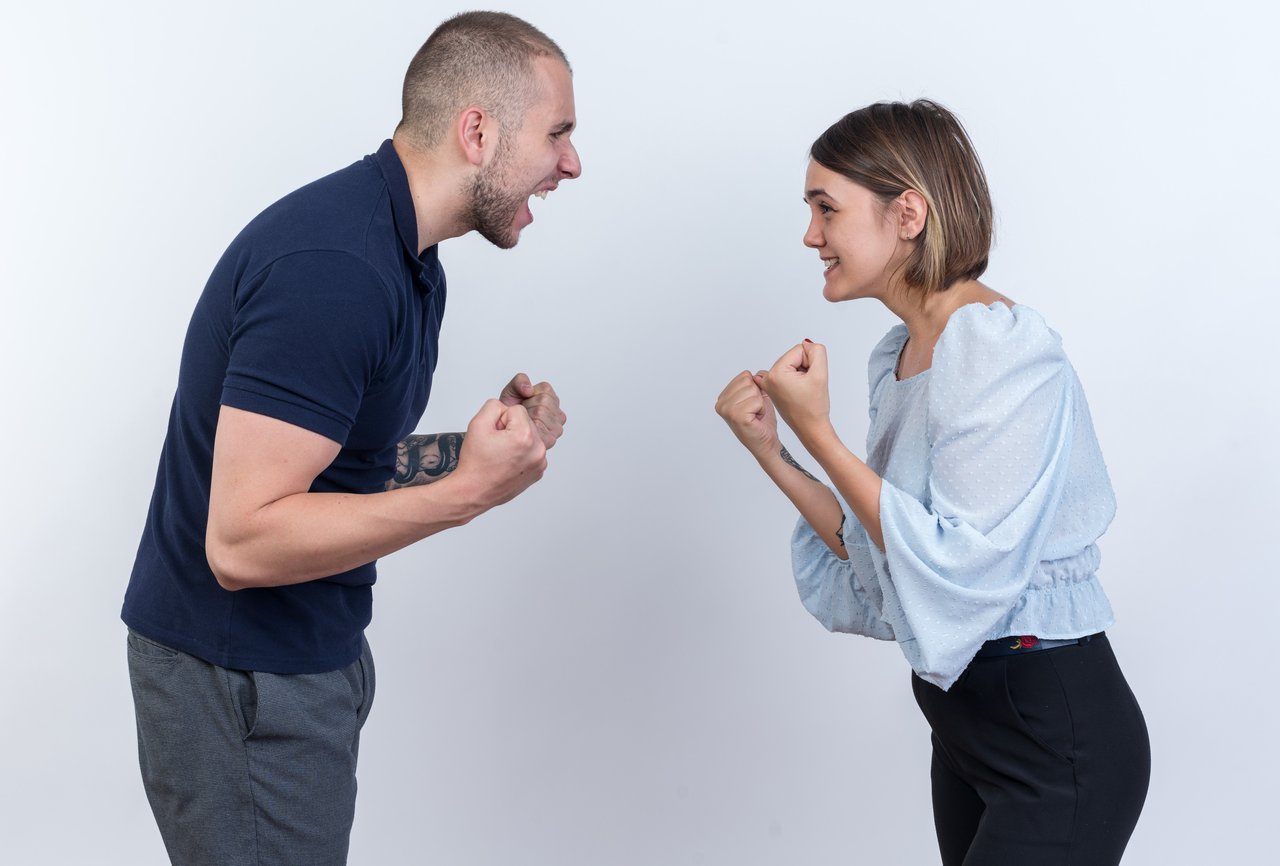 young-beautiful-couple-man-woman-quarreling-shouting-with-clenched-fists-standing-white-wall